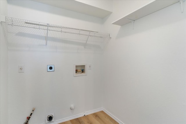 1025 Doras Dr, Pflugerville, TX 78660 - washroom featuring hookup for a gas dryer, electric dryer hookup, hookup for a washing machine, and light wood-style flooring