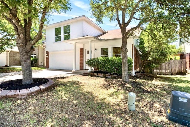 1025 Doras Dr, Pflugerville, TX 78660 - view of front of property with an attached garage, driveway, and brick siding