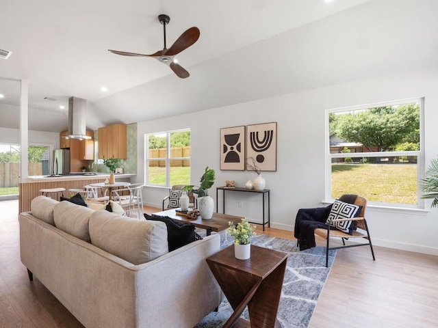 2401 Lendall Ln, Austin, TX 78744 - living room featuring lofted ceiling, a ceiling fan, light wood finished floors, and baseboards