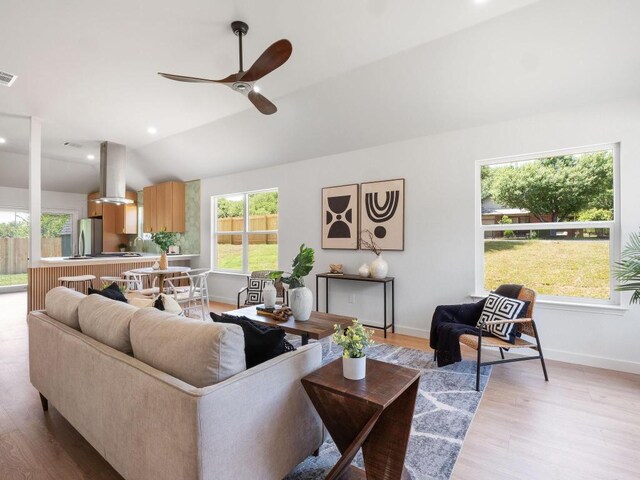 2401 Lendall Ln, Austin, TX 78744 - living area featuring lofted ceiling, a ceiling fan, light wood-style flooring, and baseboards