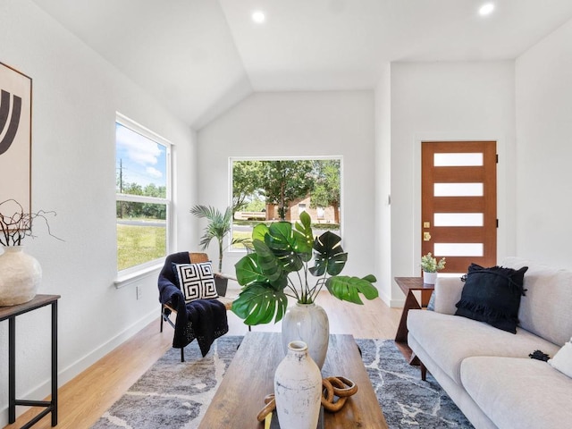 2401 Lendall Ln, Austin, TX 78744 - living area featuring wood finished floors, baseboards, vaulted ceiling, and recessed lighting