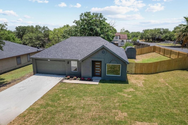 2401 Lendall Ln, Austin, TX 78744 - view of front facade featuring a shingled roof, concrete driveway, an attached garage, brick siding, and a shed