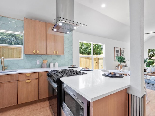 2401 Lendall Ln, Austin, TX 78744 - kitchen with island range hood, a sink, gas stove, stainless steel microwave, and light countertops