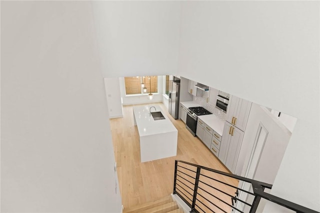 3321 Hemlock Ave Unit 2, Austin, TX 78722 - stairway featuring wood finished floors and a towering ceiling