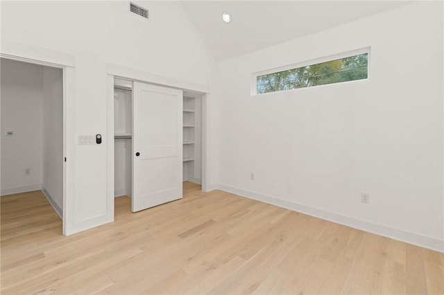 3321 Hemlock Ave Unit 2, Austin, TX 78722 - unfurnished bedroom featuring a closet, light wood-type flooring, and high vaulted ceiling