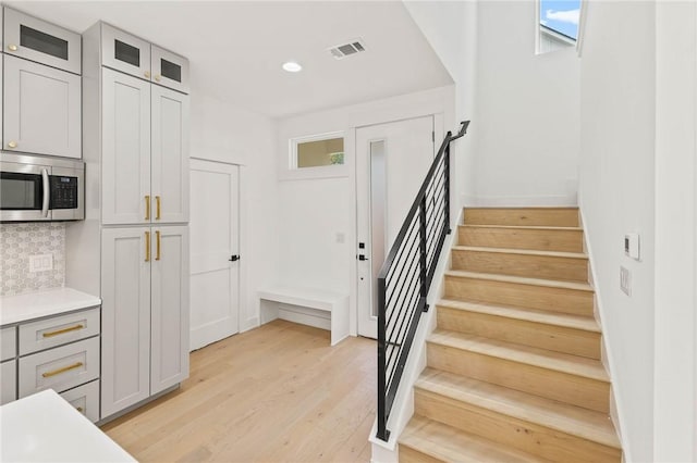 3321 Hemlock Ave Unit 2, Austin, TX 78722 - stairs featuring wood finished floors and recessed lighting