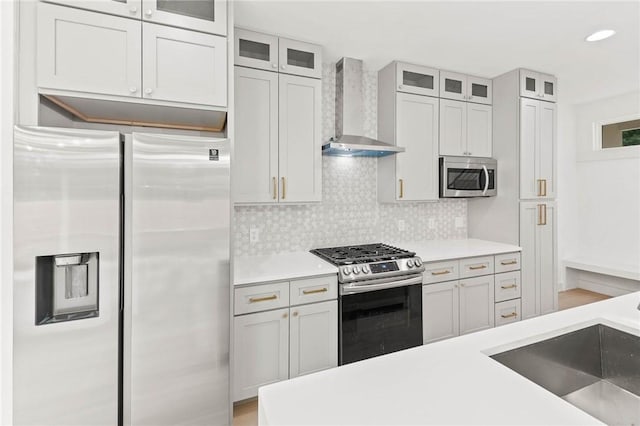 3321 Hemlock Ave Unit 2, Austin, TX 78722 - kitchen with stainless steel appliances, wall chimney exhaust hood, decorative backsplash, light countertops, and recessed lighting