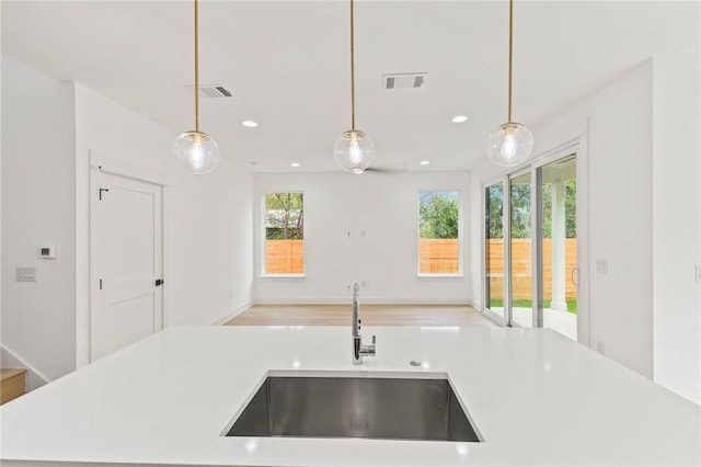 3321 Hemlock Ave Unit 2, Austin, TX 78722 - kitchen featuring open floor plan, light countertops, hanging light fixtures, and recessed lighting