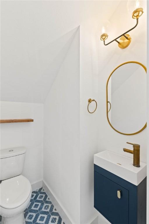 3321 Hemlock Ave Unit 2, Austin, TX 78722 - bathroom with vanity, vaulted ceiling, and tile patterned flooring