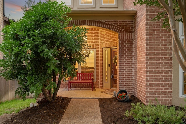 13129 Halsell Dr, Austin, TX 78732 - exterior entry at dusk with brick siding and stucco siding