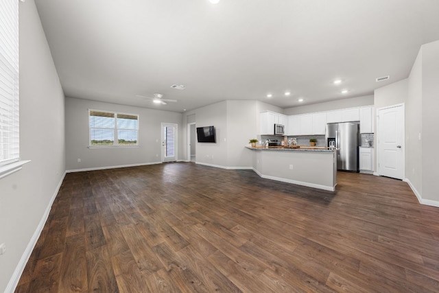 208 Bunting Ln, Bertram, TX 78605 - unfurnished living room featuring baseboards, dark wood-style flooring, ceiling fan, and recessed lighting