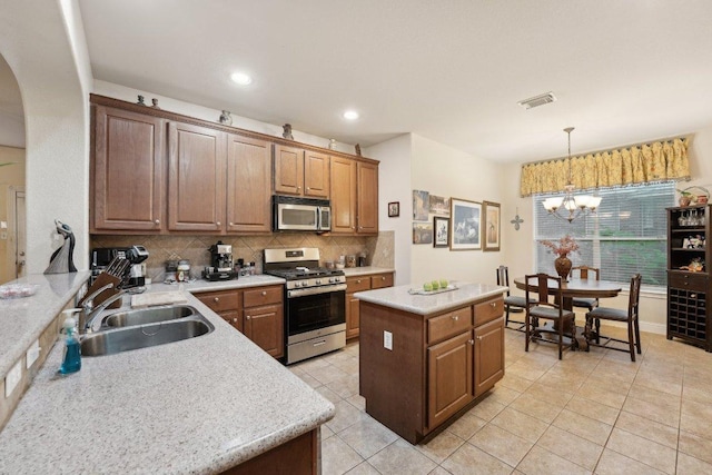 3822 Sky Ln, Round Rock, TX 78681 - kitchen with stainless steel appliances, a sink, arched walkways, light tile patterned floors, and decorative backsplash