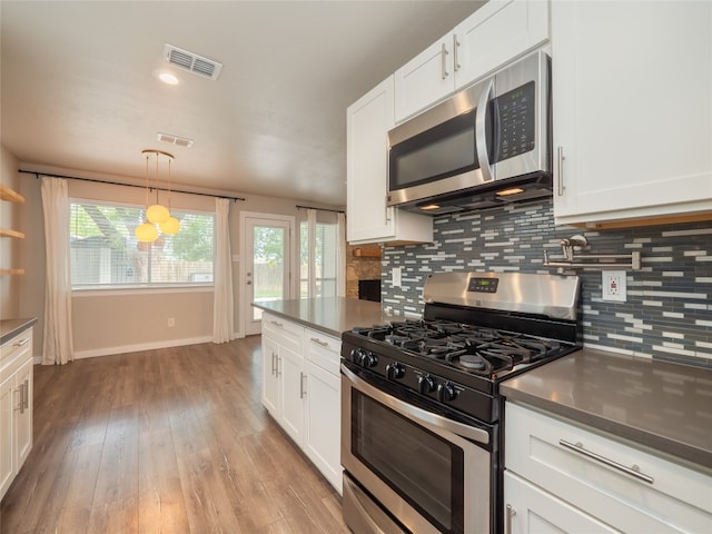 8100 Beaconcrest Dr, Austin, TX 78748 - kitchen with stainless steel appliances, tasteful backsplash, white cabinets, and plenty of natural light