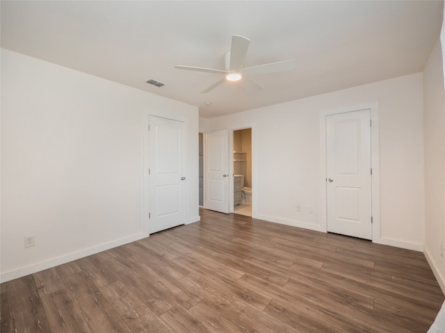 8100 Beaconcrest Dr, Austin, TX 78748 - unfurnished bedroom with wood finished floors, ensuite bath, and a ceiling fan