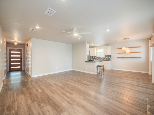 8100 Beaconcrest Dr, Austin, TX 78748 - unfurnished living room featuring light wood finished floors, a ceiling fan, and recessed lighting