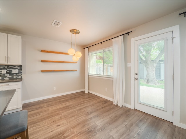 8100 Beaconcrest Dr, Austin, TX 78748 - unfurnished dining area featuring light wood-style flooring and baseboards