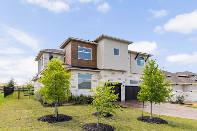 904 Arundel Rd, Lakeway, TX 78738 - contemporary home with an attached garage, driveway, and stone siding