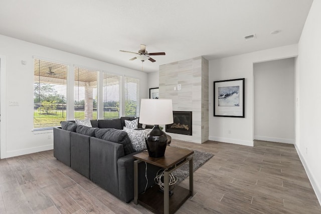 904 Arundel Rd, Lakeway, TX 78738 - living room with ceiling fan, baseboards, wood finished floors, and a fireplace
