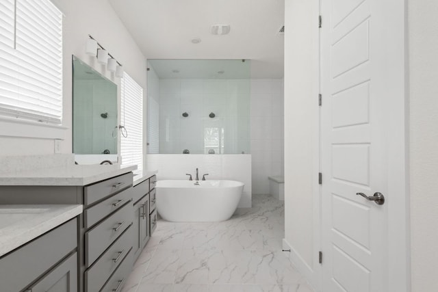 904 Arundel Rd, Lakeway, TX 78738 - bathroom featuring walk in shower, marble finish floors, a freestanding tub, and vanity