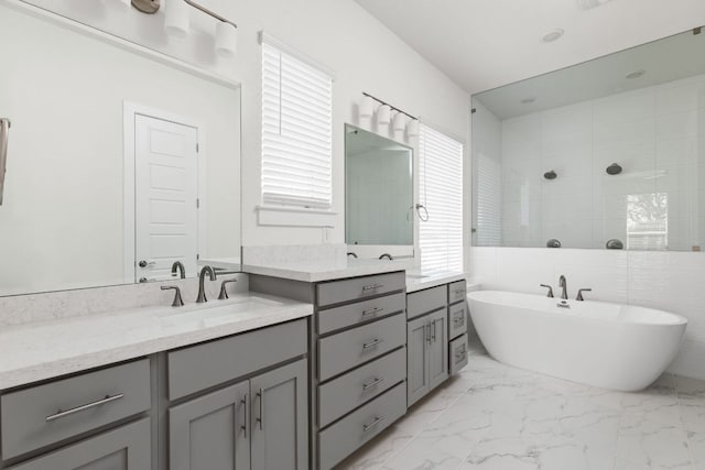 904 Arundel Rd, Lakeway, TX 78738 - full bath featuring double vanity, a freestanding bath, marble look tile flooring, and tiled shower