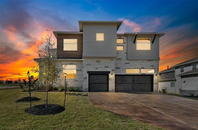 904 Arundel Rd, Lakeway, TX 78738 - view of front of home featuring a garage, driveway, stone siding, a lawn, and stucco siding