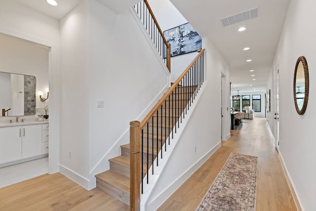 4303 Hank Ave, Austin, TX 78745 - staircase with wood finished floors and recessed lighting