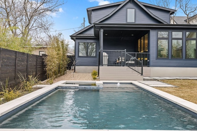 4303 Hank Ave, Austin, TX 78745 - rear view of house featuring a fenced backyard and a pool with connected hot tub