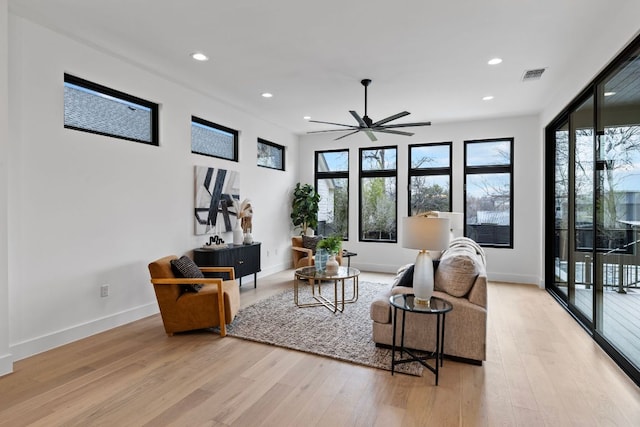 4303 Hank Ave, Austin, TX 78745 - living area featuring light wood-type flooring, ceiling fan, and recessed lighting