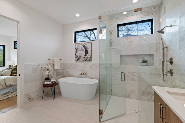 4303 Hank Ave, Austin, TX 78745 - full bath with plenty of natural light, tile walls, a stall shower, a freestanding bath, and connected bathroom