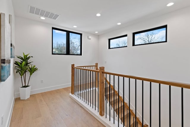 4303 Hank Ave, Austin, TX 78745 - hall featuring light wood-type flooring, recessed lighting, and an upstairs landing