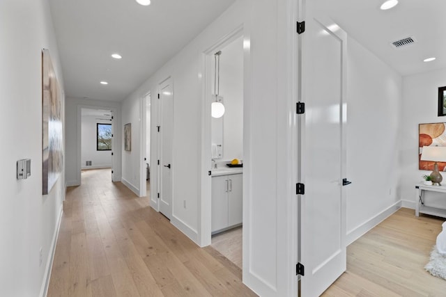 4303 Hank Ave, Austin, TX 78745 - hallway featuring light wood finished floors and recessed lighting