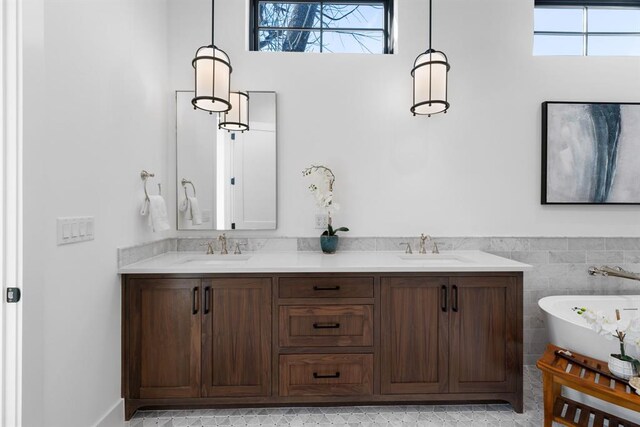 1207 Aggie Ln, Austin, TX 78757 - full bath featuring a freestanding tub, healthy amount of natural light, double vanity, and a wainscoted wall