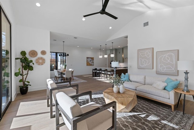 1207 Aggie Ln, Austin, TX 78757 - living room with a ceiling fan, wood finished floors, high vaulted ceiling, and recessed lighting