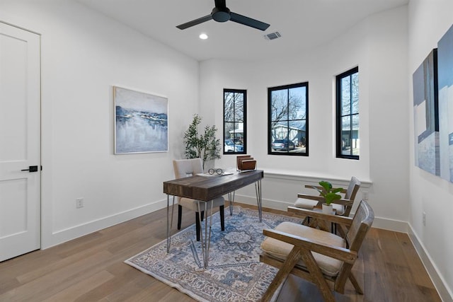 1207 Aggie Ln, Austin, TX 78757 - home office with wood finished floors, ceiling fan, and recessed lighting