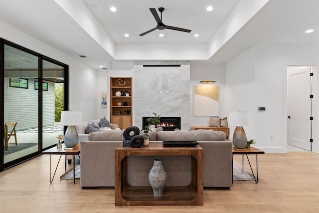 6505 Nasco, Austin, TX 78757 - living room with ceiling fan, light wood-style floors, a fireplace, recessed lighting, and baseboards