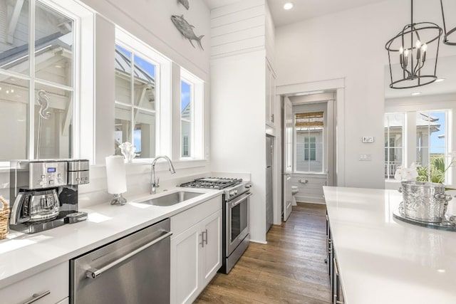 214 Sunset Ave Unit 5, Port Aransas, TX 78373 - kitchen with appliances with stainless steel finishes, a sink, white cabinetry, healthy amount of natural light, and recessed lighting
