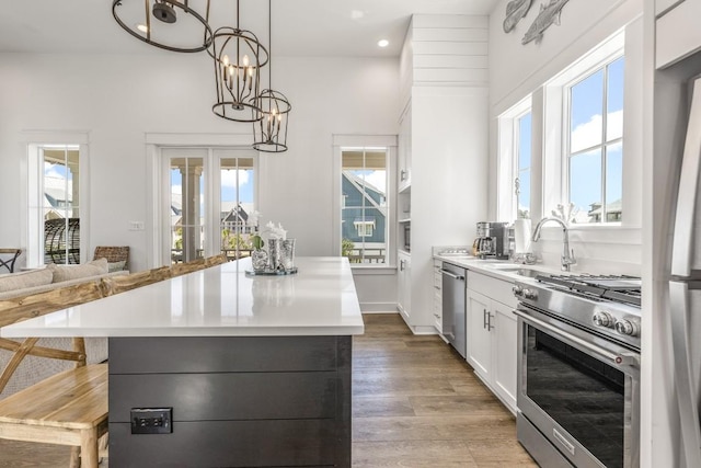 214 Sunset Ave Unit 5, Port Aransas, TX 78373 - kitchen with stainless steel appliances, light countertops, a kitchen island, a sink, and recessed lighting