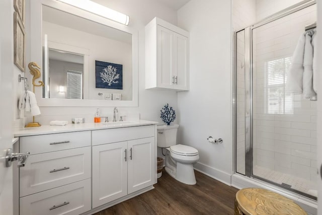 214 Sunset Ave Unit 5, Port Aransas, TX 78373 - bathroom featuring toilet, vanity, a shower stall, and wood finished floors