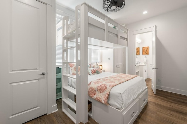 214 Sunset Ave Unit 5, Port Aransas, TX 78373 - bedroom with dark wood-style floors, baseboards, recessed lighting, and connected bathroom
