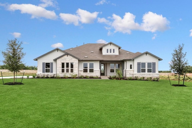 3236 Honeywood Dr, Leander, TX 78641 - back of property with stone siding, a lawn, stucco siding, and a shingled roof
