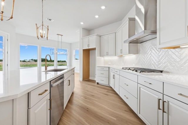 3236 Honeywood Dr, Leander, TX 78641 - kitchen with wall chimney range hood, stainless steel appliances, a chandelier, backsplash, and recessed lighting