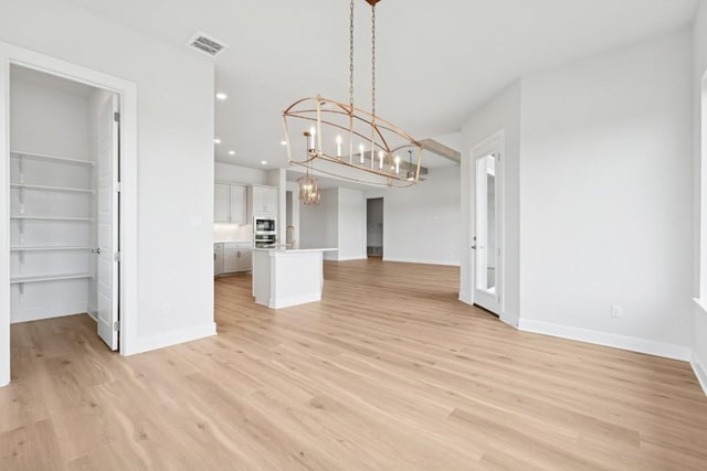 3236 Honeywood Dr, Leander, TX 78641 - unfurnished dining area with a chandelier, light wood-style flooring, and recessed lighting