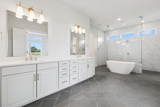3236 Honeywood Dr, Leander, TX 78641 - bathroom with double vanity, a marble finish shower, a freestanding tub, and recessed lighting