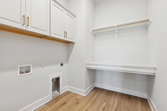 3236 Honeywood Dr, Leander, TX 78641 - laundry area featuring cabinet space, light wood finished floors, hookup for a washing machine, electric dryer hookup, and gas dryer hookup
