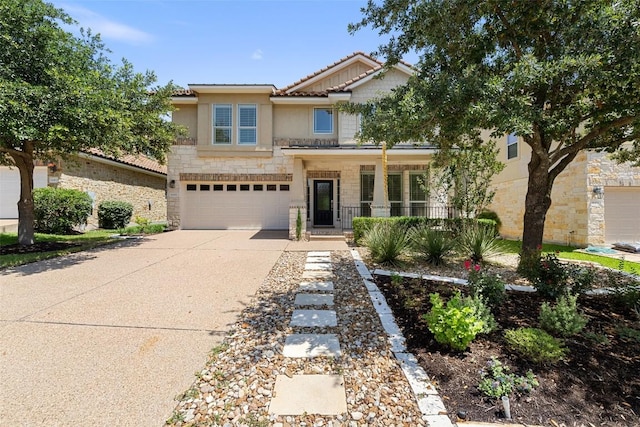 14408 Broadwinged Hawk Dr, Austin, TX 78738 - view of front of home with stone siding, a porch, driveway, a tile roof, and a garage
