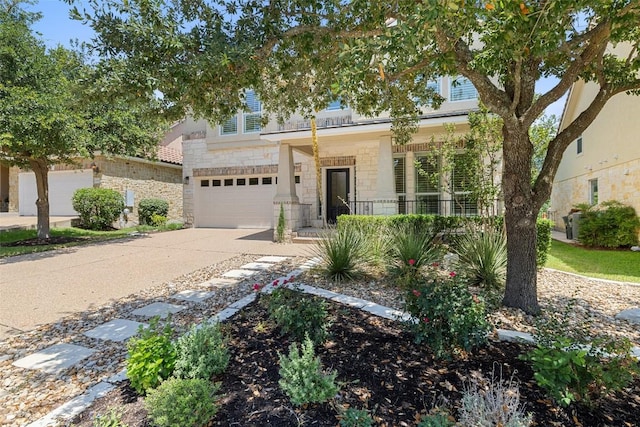 14408 Broadwinged Hawk Dr, Austin, TX 78738 - view of front of house featuring stone siding, covered porch, driveway, and a garage