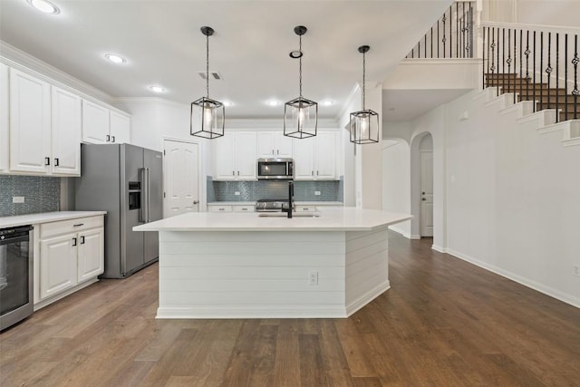 14408 Broadwinged Hawk Dr, Austin, TX 78738 - kitchen with appliances with stainless steel finishes, a sink, arched walkways, backsplash, and recessed lighting