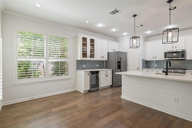 14408 Broadwinged Hawk Dr, Austin, TX 78738 - kitchen featuring stainless steel appliances, crown molding, light countertops, wine cooler, and white cabinets
