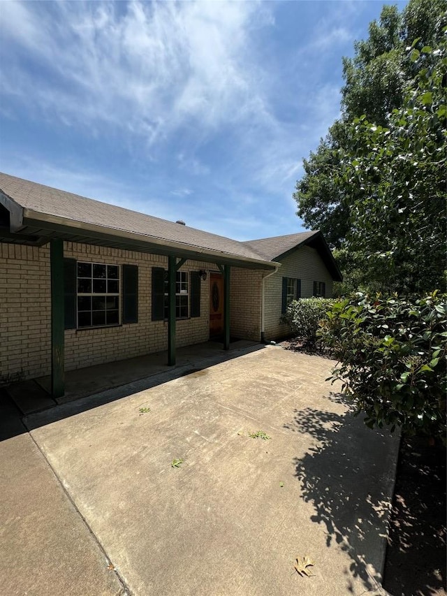 405 Lynch St, Smithville, TX 78957 - back of house featuring brick siding and a patio area