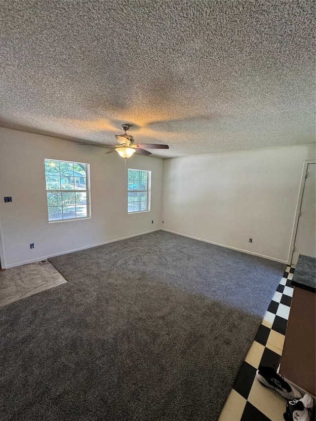 405 Lynch St, Smithville, TX 78957 - carpeted empty room featuring ceiling fan, a textured ceiling, and tile patterned floors